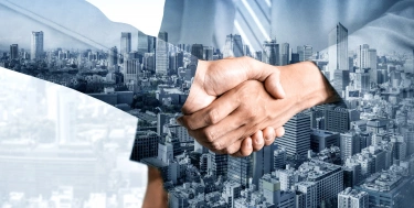 Handshake + Gebäude