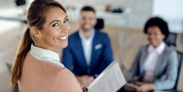 Junge, glückliche Frau bei einem Jobinterview im Büro