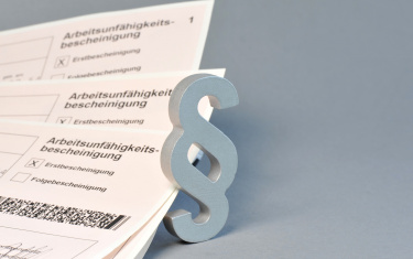 Arbeitsunfähigkeitsbescheinigung + Paragrafenzeichen